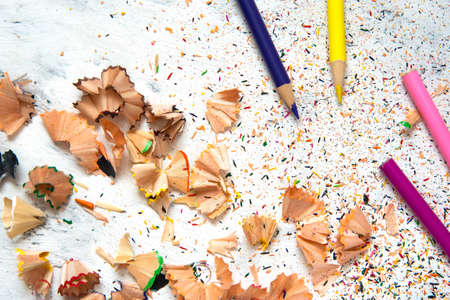 Shavings from multicolored pencils on white background.の写真素材