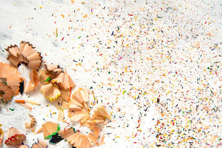Shavings from multicolored pencils on white background.の写真素材