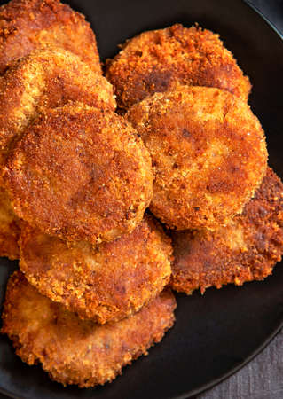 Juicy homemade cutlets on a black plate. Close up