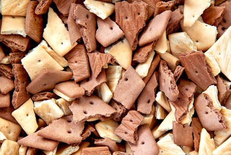 Top view of chocolate graham crackers broken into pieces of crumbs. Background graham crackers.の写真素材