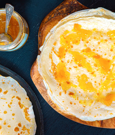 Homemade thin pancakes with apricot jam - marmalade. Thin Crepes.の写真素材