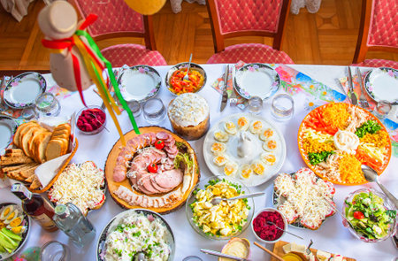 Easter breakfast with traditional holiday dishes and Easter cakeの写真素材
