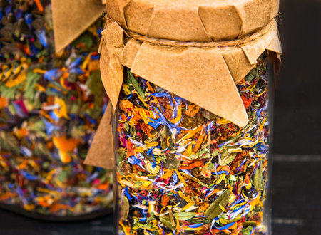 Glass jars with dried flowers and herbal tea leaves. Rose, strawberry, wild strawberry, chamomileの写真素材