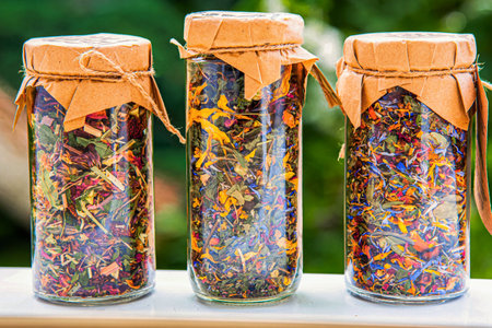Assortment of glass jars with dried flowers and herbal tea leaves. Rose, strawberry, wild strawberry, chamomileの写真素材