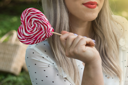 Vintage photo of lollipop woman. Summer lifestyle portrait. Smiling and having fun. Positive emotions. Close up photo.の写真素材