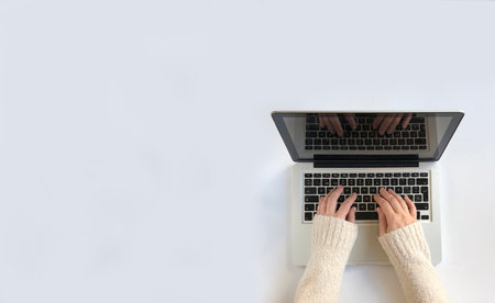 Woman typing on laptop on white. background