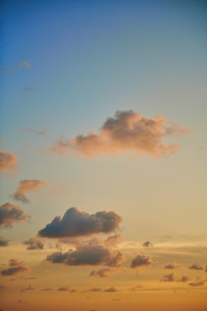 Cloudscape, Colored Clouds at Sunset near the Ocean on a Cloudy Dayの写真素材