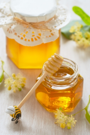 Two jars of linden honey and spoon of honeyの写真素材