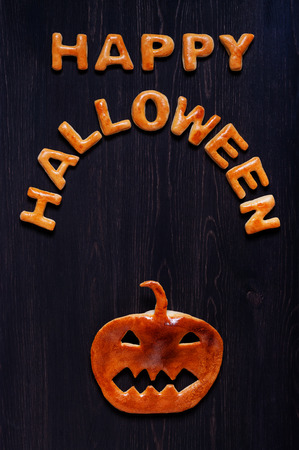 Letters and pumpkin of dough on the wooden table. Halloween backgroundの写真素材