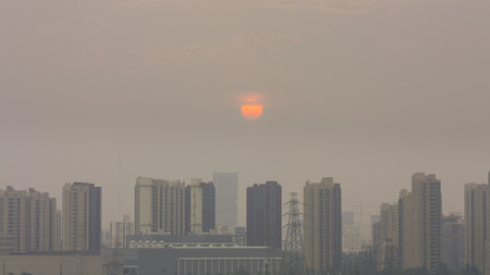 High angle horizontal building shot of sunset in beijing on a foggy dayの写真素材