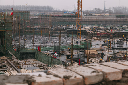 18 Dec,2014 Beijing. Work activity on a construction site in City with cranes and workers,building train stationのeditorial素材