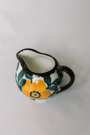 a white tea cup  with floral and line pattern on white backgroundの写真素材