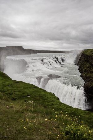 beautiful flowing water waterfall on icelandの写真素材