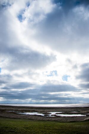 rays of sun through clouds above the seaの写真素材
