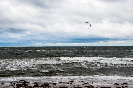 one kite surfer in stormy seaの写真素材