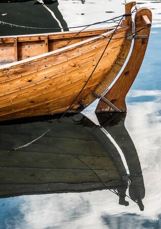 wooden fishing boat mirror seaの写真素材