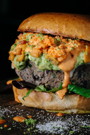 Spicy veggie burger on dark backgroundの写真素材