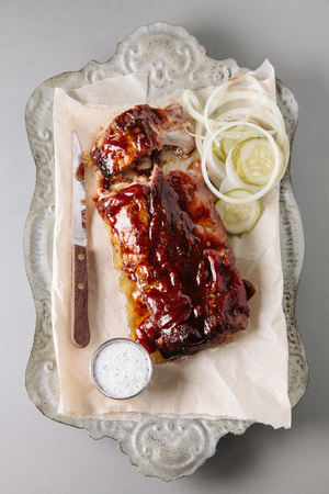 Smoked bbq baby back ribs on a vintage trayの写真素材