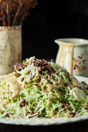 Gourmet salad with lettuce, shredded parmesan, toasted pecans and mustard vinaigretteの写真素材