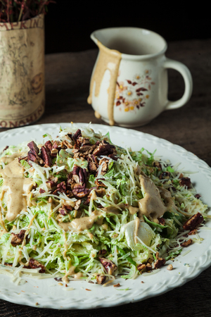 Gourmet caesar with lettuce, shredded parmesan, toasted pecans and mustard vinaigretteの写真素材