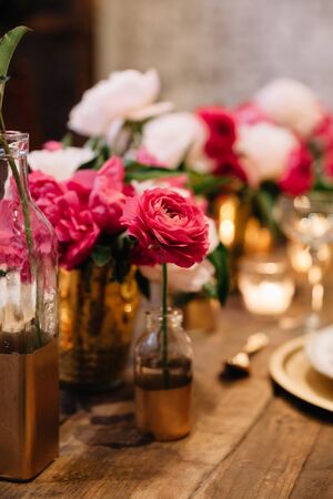 Pink ranunculuses, white peonies for a candelit wedding receptionの写真素材