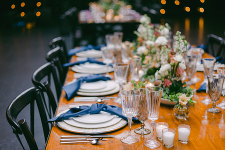 A beautifully arranged dining table showcases fine china and glassware, complemented by fresh...