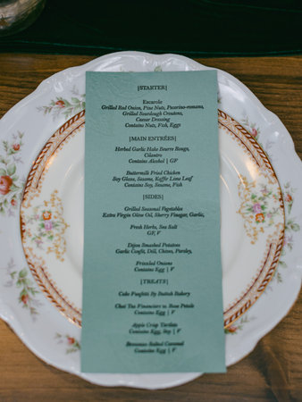 A beautifully arranged table displays a gourmet menu featuring various dishes. The setting...