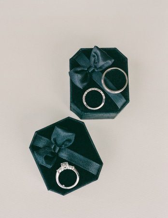 Sparkling rings are showcased in a luxurious velvet box with a satin bow, perfect for a romantic moment or celebration.の写真素材