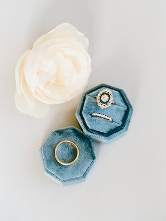 Elegant rings and a decorative flower set a romantic mood for any special occasion or engagement.