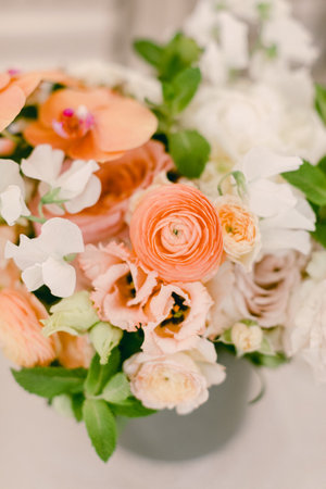 Vibrant blooms in soft shades of orange and white create an inviting spring atmosphere in a modern...