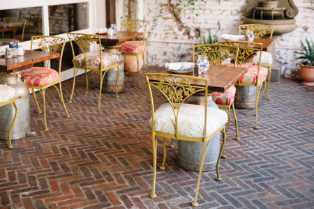 Stylish outdoor dining area features cozy tables and colorful chairs, inviting guests to enjoy a...