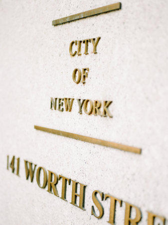 Brass letters indicate the official address and name of a city building in New York, showcasing urban architecture.の写真素材