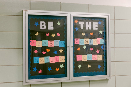 Colorful letters and shapes invite students to spread positivity and make someone smile today in a school setting.の写真素材