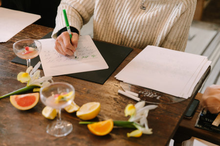 Handwriting practice takes place at a workshop with drinks and flowers enhancing the inviting...