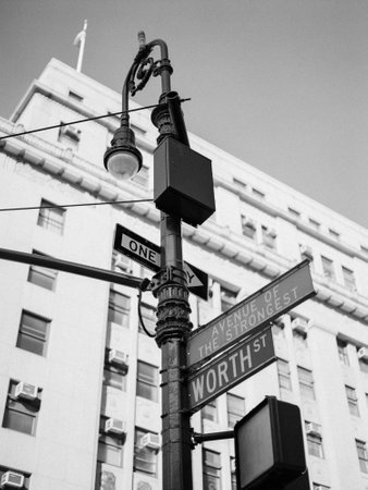 Street signs highlight Worth Street and Avenue of the Strongest, set against a backdrop of an urban...