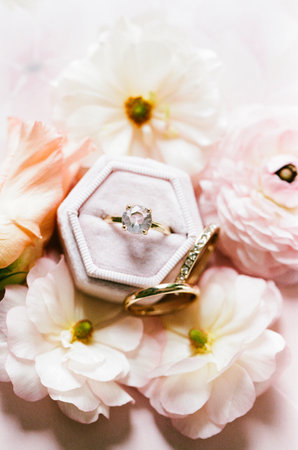 Wedding rings on pastel flowers evoke a romantic, elegant atmosphere for the perfect celebration.