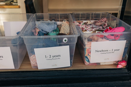 Clothing donation bins for children located outside a community center during the day
