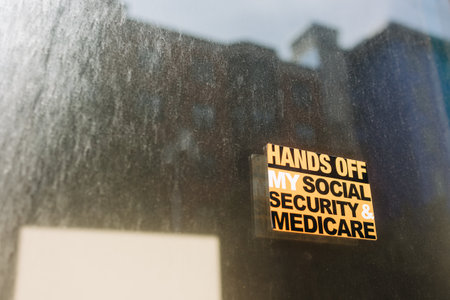 Sign displaying a warning about protecting social security and Medicare in an urban setting with a blurred backgroundの写真素材