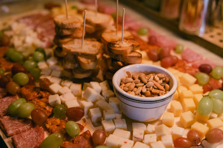 A colorful spread of cheeses, cured meats, fresh grapes, and toasted bread awaits guests at the...