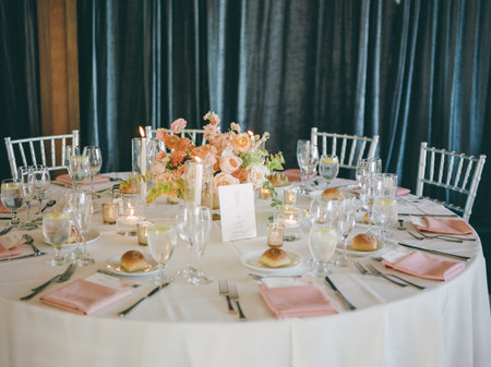 A beautifully arranged table featuring delicate floral decor, candlelight, and soft pastels for a special celebration.の写真素材