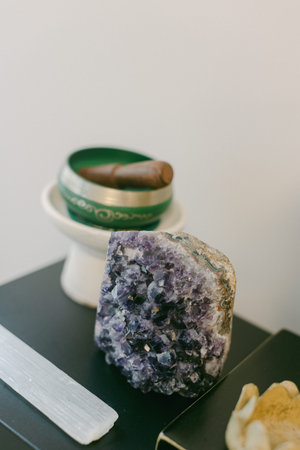 Amethyst crystal and incense holder create a tranquil atmosphere in a spacious indoor environment...
