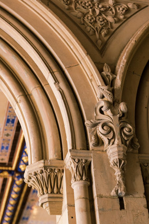 Intricate stone carvings adorn the arches of an elegant historic structure, showcasing impressive...