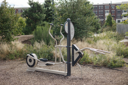 People can exercise using outdoor fitness equipment in a lush park, enjoying fresh air and sunshine.の写真素材