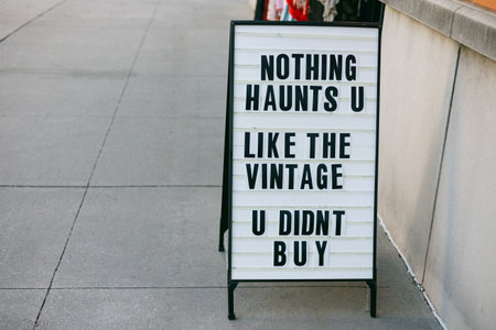 A store sign displays a playful message about vintage items, encouraging passersby to explore the...