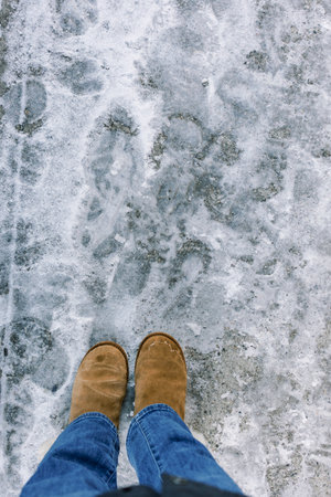 Footsteps mark a snowy path, highlighting warm boots and cold winter weather during a peaceful...