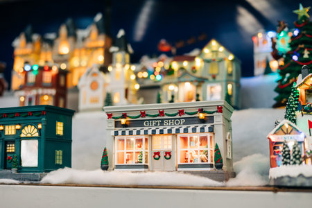 A cozy gift shop shines with lights, surrounded by a vibrant holiday village scene decorated for the season.の写真素材