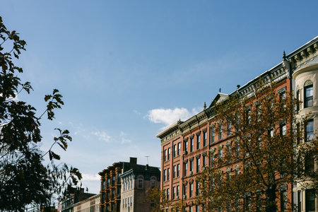 Bright afternoon light shines on historic buildings in a vibrant city of Hoboken, New Jersey, USA...