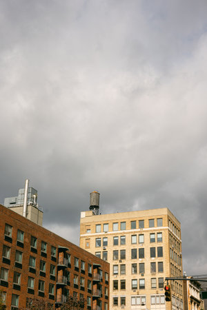 Urban buildings under cloudy sky with industrial features in the cityの写真素材