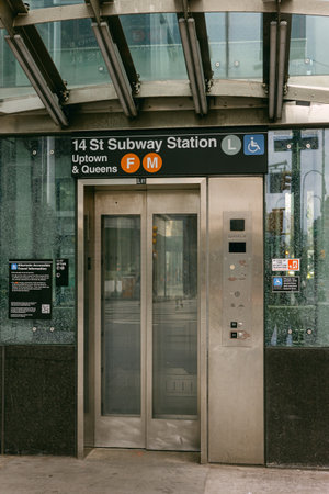 14 St subway station entrance with lift access for uptown and Queens in New York City on a clear dayの写真素材