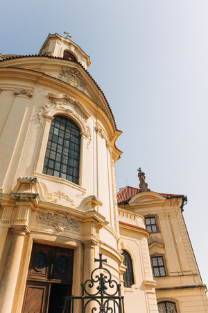 A church with intricate design stands tall beside another building in a busy city setting during...